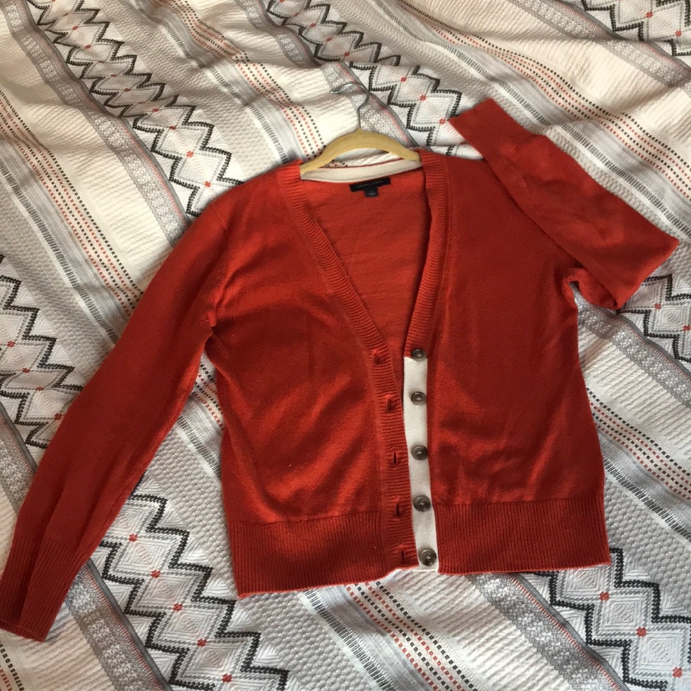 Burnt orange cardigan.